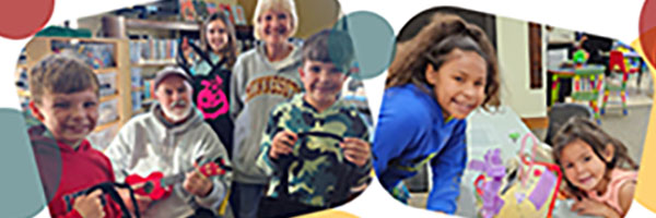 Children and adults holding up Halloween bags and pumpkins